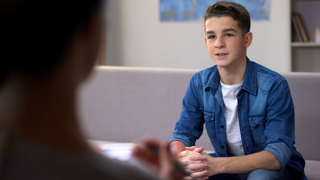 Teenage boy receiving receives stuttering therapy