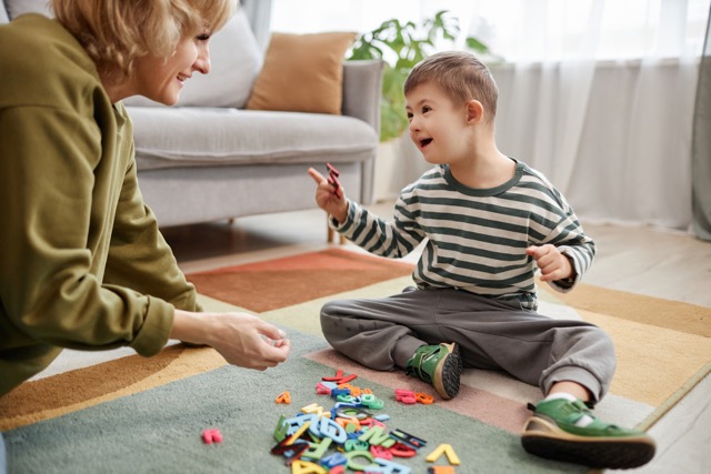 Speech therapist working with a young boy