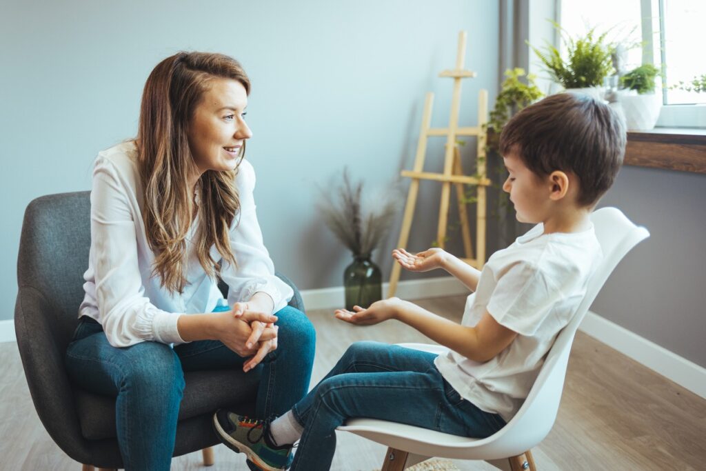 Speech therapist engaging a young child in a supportive one-to-one communication session