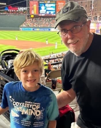 John Burke with grandson at a baseball game