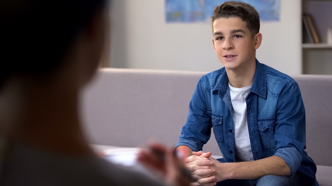 Teen working with a speech therapist to improve communication and social skills.
